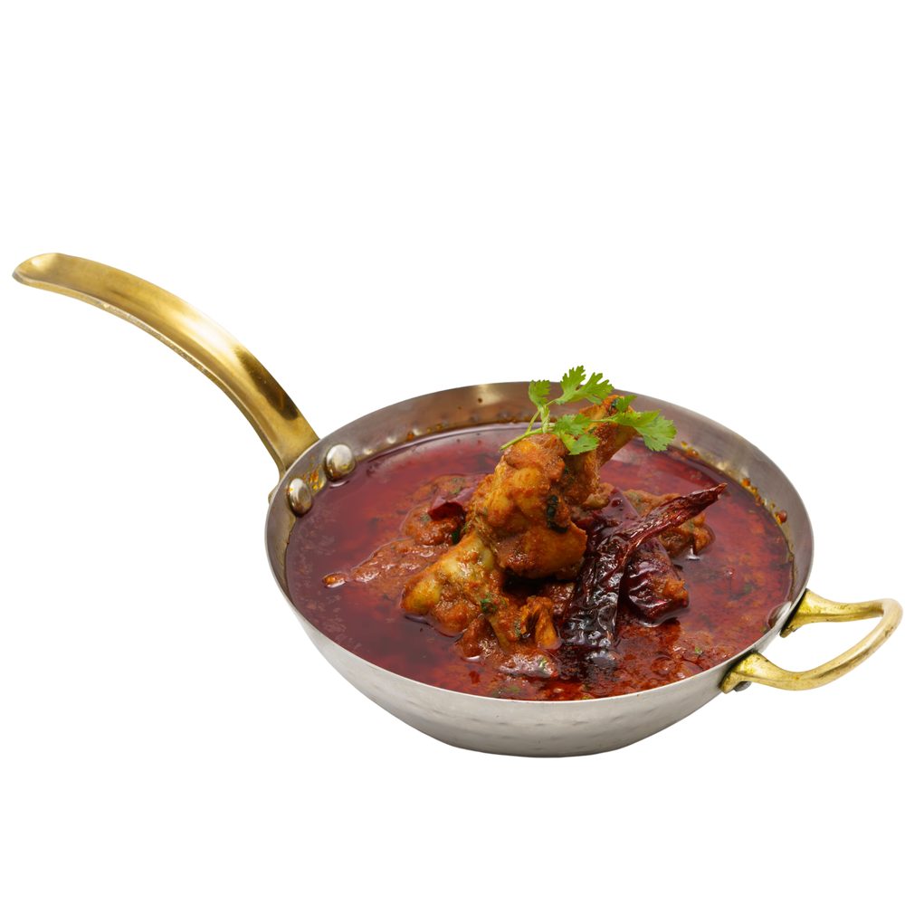 Chicken curry served in a kadai